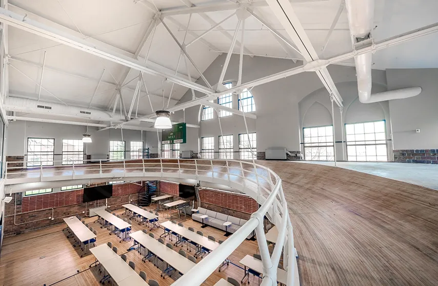 An indoor running track is suspended over a newly remodeled classroom.